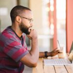 man searching the internet for information - looking for a roofing contractor