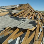 Storm-damaged roof featuring scattered shingles and structural exposure. Storm Damage Repair. What Homeowners should know.